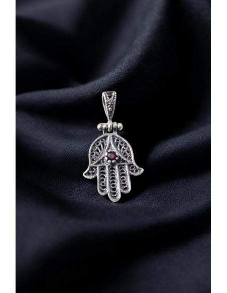 Fatima hand pendant adorned with a purple pearl.