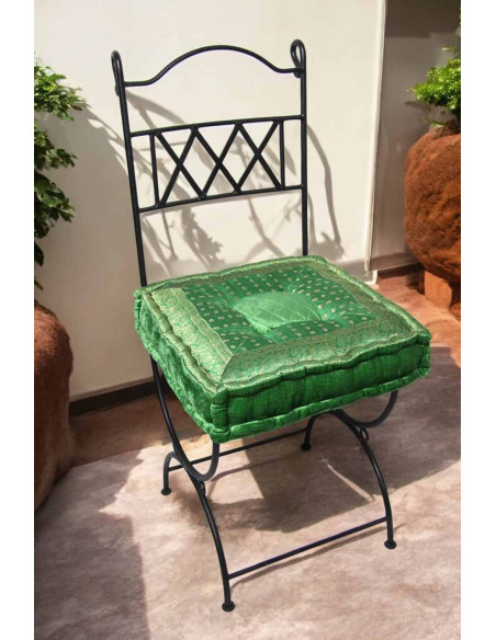 Wrought iron chair with green cushion