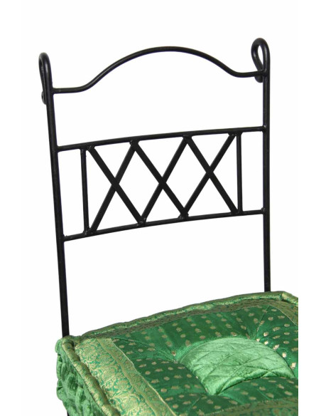 Wrought iron chair with green cushion