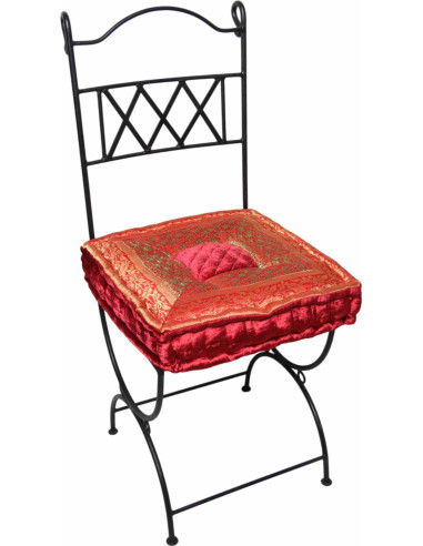 Wrought iron chair with red-orange cushion